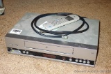 Zenith VHS video player with remote, seller states that it works. Cabinet measures 14
