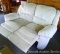 Reclining loveseat is comfortable and reclines as it should. Measures approx. 5' 4