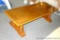 Solid wood coffee table has a glass top added. Sturdy table measures 58
