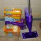 Swiffer Wet Jet comes with opened boxes of Swiffer dusters and Wet Jet pads. Stands about 4' tall.