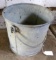 Heavy duty galvanized steel bucket has a factory strapped reinforced bottom. Super well made.