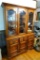 Nice hutch has lighted upper cabinet with glass doors for display and lower cabinet for storage.
