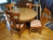 Antique pedestal table has four matching chairs. Top has been replaced with formica. Comes with two