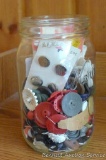 Quart jar about 2/3 full of vintage buttons.