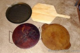 Two Pampered Chef stoneware pizza pans, one with wire rack. Larger is 18