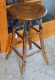 Wonderful antique stool. Seat height adjusts by turning stool top. One cast bracket to support seat