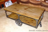 Industrial style coffee table is sturdy and in good condition. Measures 4' x 26