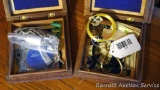 Two trinket boxes with contents. Contents include replacement Seiko watch band, bracelets,