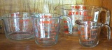 Three Pyrex and one Anchor brand glass measures. Largest is 2 quart, smallest is 1 cup.