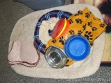 18 gallon tote with dog dishes, beds, frisbees, blanket, etc.