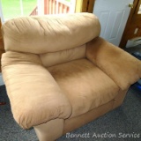 Overstuffed arm chair matches couch in lot 254. Upholstery is in overall good condition, has a