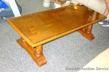 Solid wood coffee table has a glass top added. Sturdy table measures 58