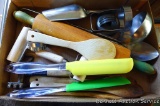 Vintage and newer kitchen tools including green handled wooden rolling pin, biscuit cutter, ladle,
