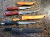 Three filet knives by Normark of Sweden. Two smaller knives have leather sheathes made in Finland.