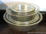 Set of four nesting clear glass Pyrex mixing bowls, largest is 12