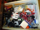 Kitchen junk drawer includes timer, binoculars, assorted screwdrivers, tape measure, window points,