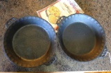 Two cast iron pie plates by Camp Chef Home, plus pamphlet. Each pan is approx. 10