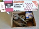 Box of light bulbs; oil filter wrenches; CarQuest 85348 oil filter; metal oil can nozzle.