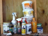 Partial containers of horse care products.