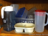 Plastic pitchers and storage containers as pictured.