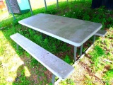 Metal frame picnic table with plastic top and seats is 6' long.