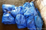 Four or more blue tarps. Pile as pictured is approx. 4' wide x 2' tall.