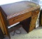 Singer Sewing Machine in cabinet. Cabinet drawers contain accessories and notions. Graphics on