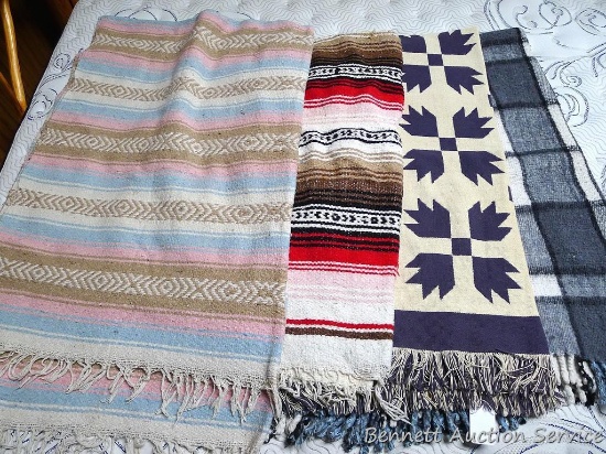 Four heavy weight blankets. Largest is 78" x 60". One has a hole along one edge. Some stains noted.