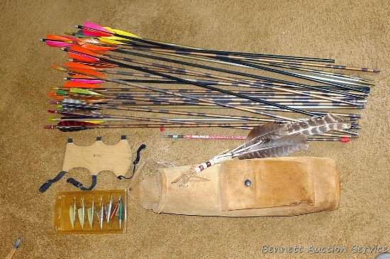 Leather quiver with assorted broadheads and aluminum arrows. Quiver measures 17" x 6-1/2". Also