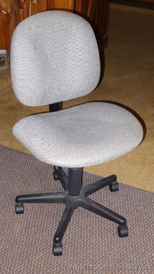 Rolling padded office chair has adjustable back and height. Chair is 37" tall.