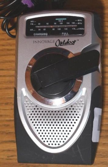 Innovage Outdoor hand crank weather band AM/FM radio is 3-1/2" x 6". Comes with power cord and ear