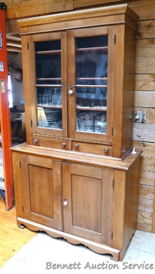 Wooden china cabinet is 20-1/2" x 49" x 84-1/2" tall. Has glass insert doors on top and 3 wooden