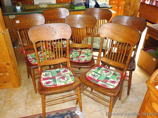 Set of six dining chairs, plus one other. Set of six have logo embossed on back