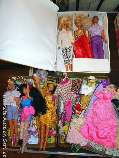 Six Barbies and a Ken doll, plus clothes , shoes, and a carry case. Case is 13-1/2" x 10" x 2-1/2".