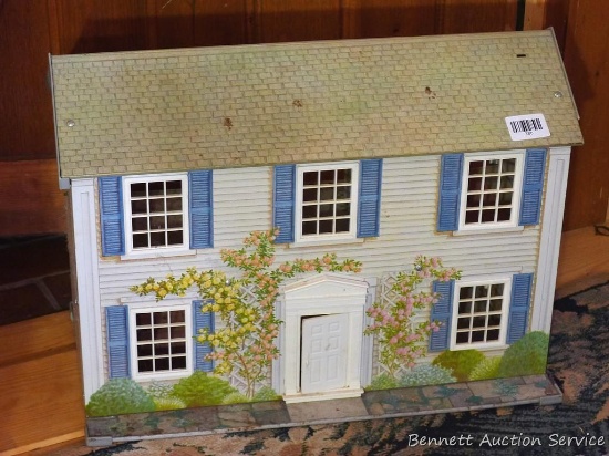 Vintage sheet metal doll house measures approx. 2' wide x 1" x 16" tall.