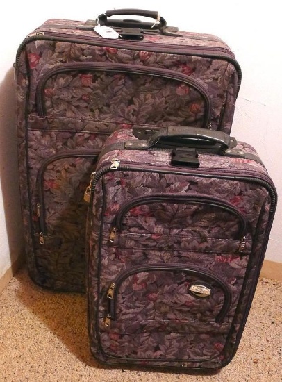 Two tapestry patterned suitcases by American Tourister, both have wheels and extendable handles.