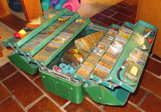 16" metal tackle box has six fold out trays and comes with contents.