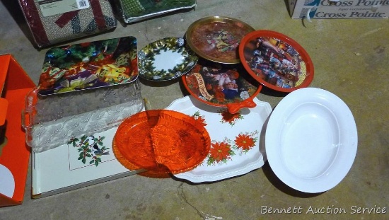 Nine plastic and metal holiday trays and a serving bowl, largest tray is approx. 13" x 19".
