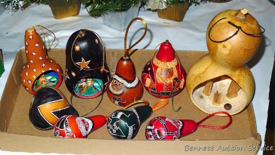 6" tall gourd has been hollowed or carved into an ornament displaying a Nativity scene; other hand