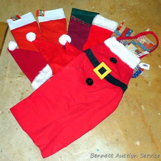 New with tags Mrs. Claus apron from Old Navy; six stockings; a few Santa hats;