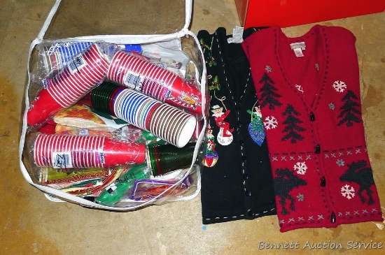 Plastic zipper tote filled with plastic cups, platter, etc; plus two ladies Christmas sweaters,
