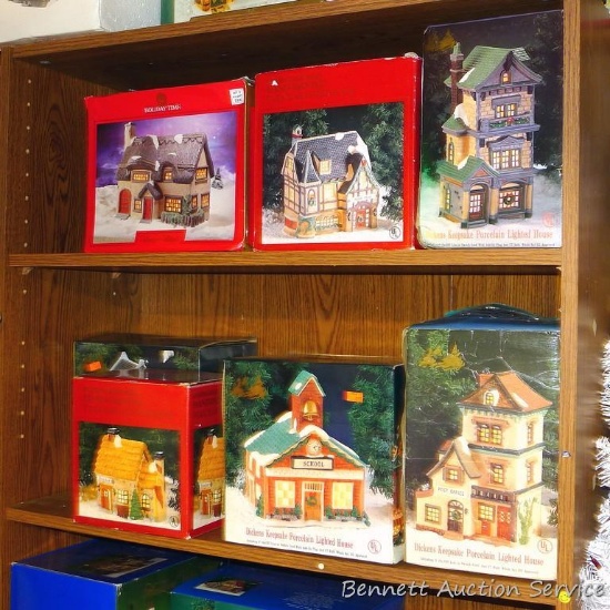 Eight lighted Christmas village pieces with original boxes.