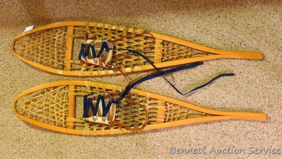 Pair of wooden snowshoes that measure 10 in. x 46 in. Both in good condition.