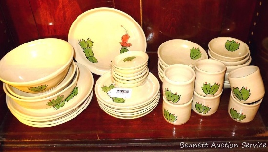 Thirty seven pcs. of ceramic dinnerware with Christmas Cactus on them by Irene Gimeno. All pieces