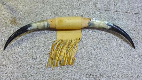 Cattle horn display is 41" across and has soft leather wrap with fringe at middle.