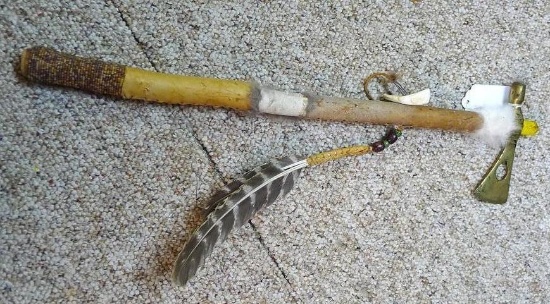Decorative tomahawk has beaded and feather accents, 22" long.