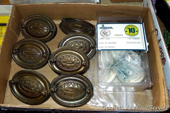 Seven drawer pulls are each 3-1/4" wide (2-1/2" from screw to screw). Ceramic knobs are 1-1/2"