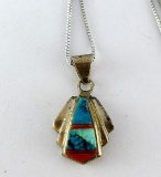 Necklace with silver toned chain and a Southwest style pendant. Necklace is overall approx. 10