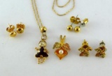 Fine gold chain and girl birthstone pendant are marked 14K, as are flat round earrings and backs;