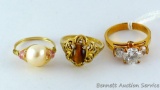 Three rings. One with tiger eye stone is size 7, marked in band '13KT HGE'. Freshwater pearl ring